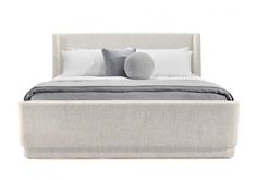 an upholstered bed with two pillows on the headboard and one foot board