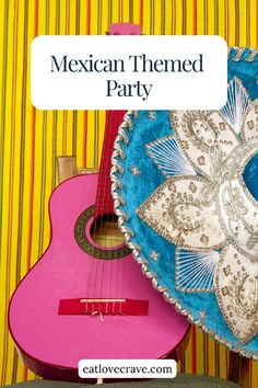 a mexican themed party with guitars and other items on the table, including a pink ukulele