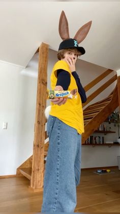 a young boy dressed up as a bunny while talking on his cell phone