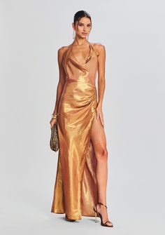 Dare to shine in our Cleo Dress. This cowl neck halter dress features a pleated detail at the hip and an ultra side slit. Shown here in Nude Glitter. 72% Silk, 28% Metallic Made in China Model is 5'10" wearing size S Style No. PF23-7060 Luxury Metallic Shiny Dress, Luxury Metallic Silk Dresses, Retrofete Gold Dress, Chic Metallic V-neck Dress, Metallic Fitted Lurex Dress, Silk Chiffon Dress, Halterneck Dress, Silk Chiffon, Designer Outfits Woman