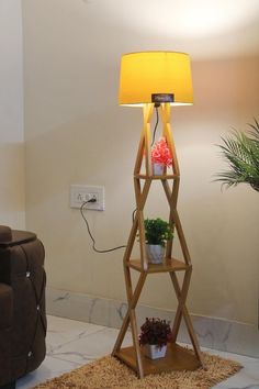 a lamp that is on top of a stand in the middle of a living room