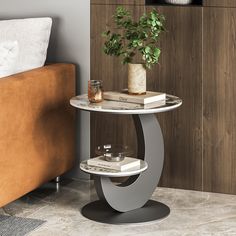 a table that has some books and a potted plant on it in front of a couch