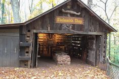 an old wooden building in the woods