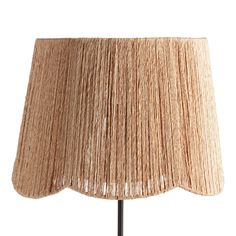 a lamp that is on top of a wooden stand with a light shade over it