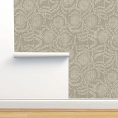 an empty room with a wallpapered background and white trim on the door frame