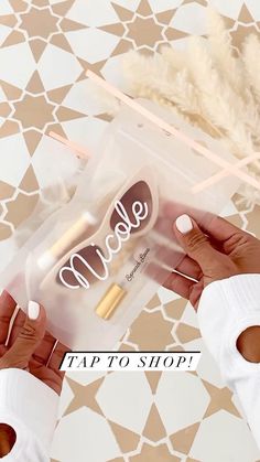 a person holding a tube of makeup next to a box with the word mollie on it