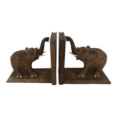 pair of elephant bookends on wooden bases