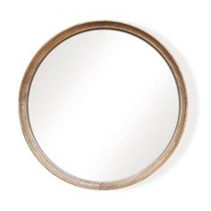 a round wooden mirror on a white wall