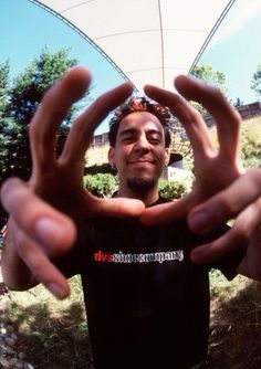 a man making the shape of a heart with his hands