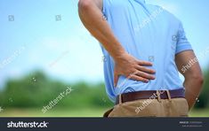 a man holding his lower back in pain