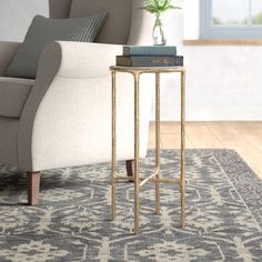 a living room with a couch, chair and side table on the carpeted floor