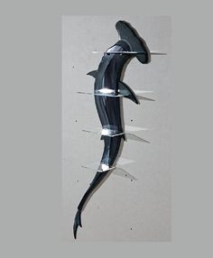 a metal sculpture that looks like a shark