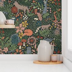 the wallpaper in this kitchen is designed with flowers and deers, while other animals are