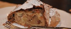 a piece of pie sitting on top of a white plate with a fork next to it