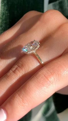 a woman's hand with a diamond ring on it