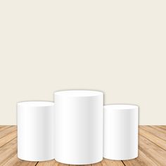 three white cups sitting on top of a wooden floor