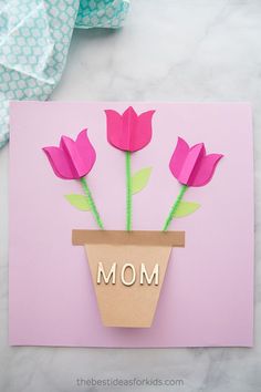 a mothers day card with flowers in a flower pot and the word mom written on it