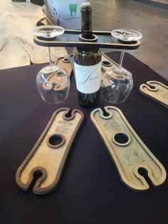 a bottle of wine sitting on top of a table next to some glasses and bottles