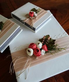 flowers are placed on top of two wedding guest bookends with twine ribbons