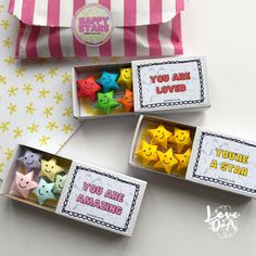 three small boxes filled with different colored stars