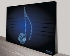 a black and blue poster with the words behind it on a wooden shelf next to a wall