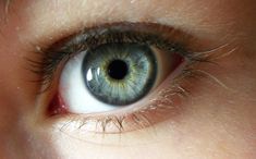 a child's blue eye is shown in this close up photo, with only the iris visible