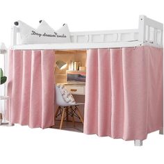 a bed with pink curtains and a white desk