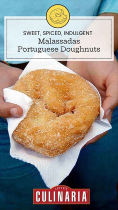 a person holding a donut in their hand with the words sweet, spiced indulgenti masadas portuguese doughnuts