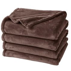 four blankets stacked on top of each other in chocolate brown color, with one blanket folded over the edge