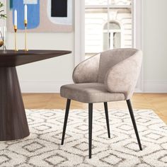 a chair sitting in front of a table on top of a rug