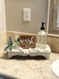 a bathroom counter with soap, toiletries and other items on it