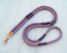 a purple and yellow leash on a white surface