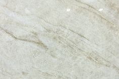 a white marble textured surface with light brown streaks