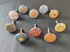 six pairs of colorful glass knobs with designs on them