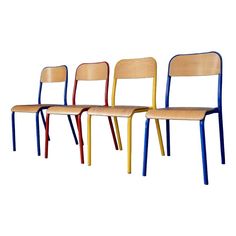 three wooden chairs with different colors on them