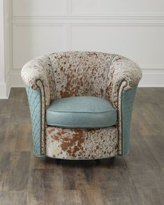 an upholstered chair with brown and blue fabric