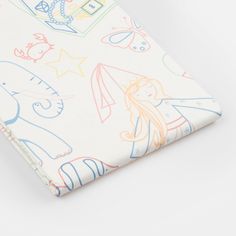 a close up of a white fabric with colorful drawings on the front and back of it