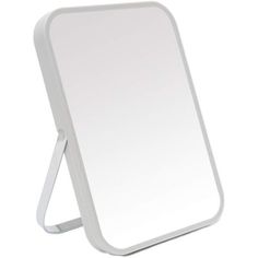 a white mirror sitting on top of a table