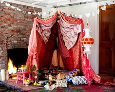 an image of a bed that has been decorated with pink and red fabric on it