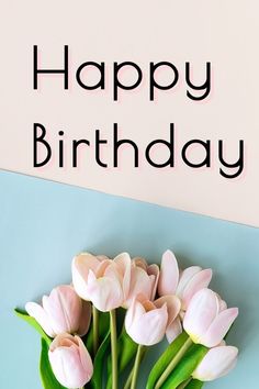 pink tulips are in a vase with the words happy birthday written on it