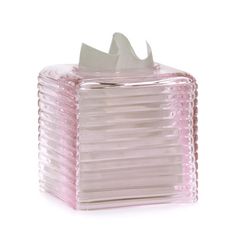 a pink glass tissue dispenser on a white background