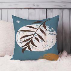 a blue pillow sitting on top of a white furnishing next to a wooden headboard