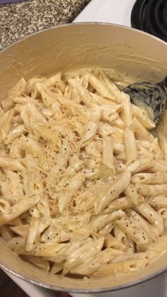 a pan filled with pasta on top of a stove