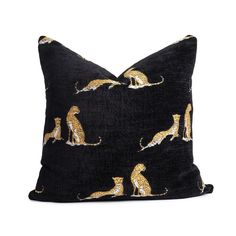 a black and gold pillow with cats on it