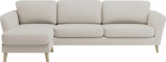 a beige couch and footstool sitting next to each other on a white background