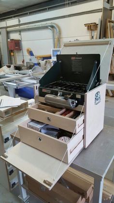 an open tool box sitting on top of a workbench