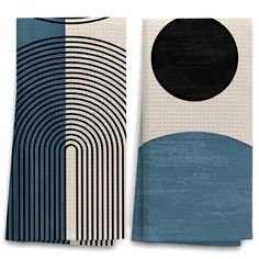 two blue and white towels with black circles on the front, one is folded in half