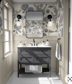 a bathroom with two sinks and a large mirror above the sink is decorated in floral wallpaper