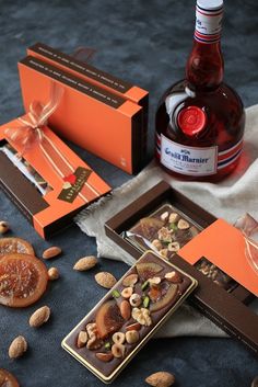 an assortment of food and drink items on a table next to a bottle of wine