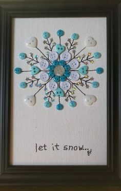 a snowflake made out of buttons with the words let it snow